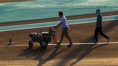 Crews prepare the track for the upcoming Grand Prix at Yas Marina Circuit.