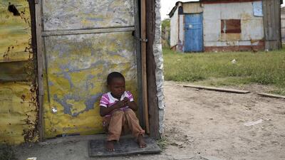 A child sits outside a locked shack in Nkaneng township, Marikana’s informal settlement, in Rustenburg. Union members have downed tools at platinum-producing miners in a strike over wages. Siphiwe Sibeko / Reuters