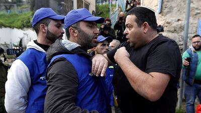 An Israeli settler argues with Palestinians wearing blue vests marking them as 'observers' during a protest against the end of the mandate for the Temporary International Presence in Hebron. Abed Al Hashlamoun / EPA
