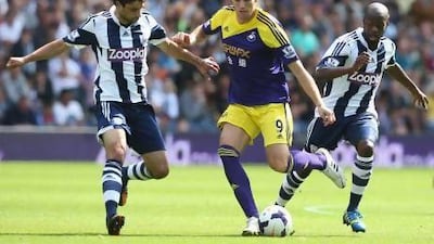 Swansea's Michu is challenged by West Brom's Claudio Yacob, left, at The Hawthorns. David Rogers / Getty Images
