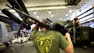 An US Marine carries his machine gun during a regular training.