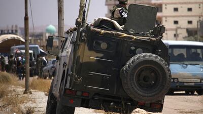 A Russian soldier on his armoured vehicle watches Syrian rebels during evacuation from Deraa city, on July 15, 2018. AFP