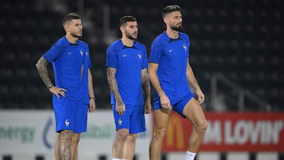 Lucas Hernandez, Theo Hernandez and Olivier Giroud take part in a training session at Al Janoub stadium in Doha, on November 21, 2022, on the eve of the Qatar 2022 World Cup football match against Australia. AFP