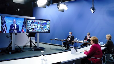 A virtual climate summit took place in July with German Chancellor Angela Merkel here looking at US President Joe Biden on screen. AP