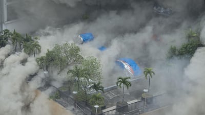 Heavy smoke engulfs the pool side of the Waterfront Manila Pavilion building, a hotel and casino complex, after a fire broke out in Manila on March 18, 2018. Ted Aljibe / AFP