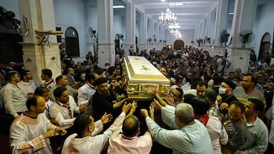 Egyptian mourners at a funeral of some of the 41 worshippers, many of them children, killed in Sunday's Abu Seifein church fire in Giza, greater Cairo. AFP
