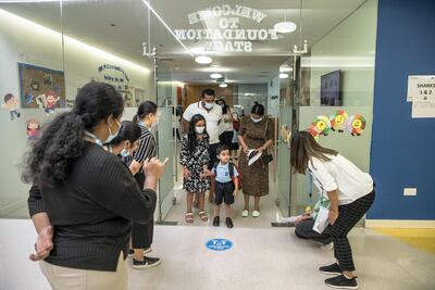 Naividh Pillai, aged 3, looks a little bewildered as he arrives for his first day at Gems Wellington Academy with sister Alaikha and parents Meera and Deepesh. Antonie Robertson / The National