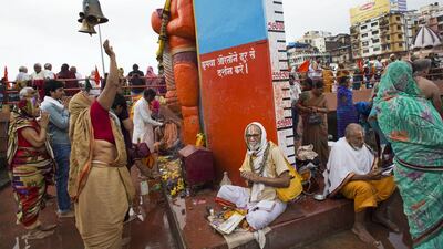Hindu pilgrims offer prayers to an idol of monkey God Hanuman.