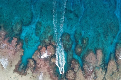 Jay Warren navigates the RIB through the only channel to land on the North beach. Iain McGregor/STUFF