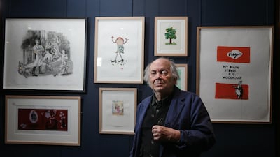 British illustrator and artist Quentin Blake poses with some of his work at Sotheby's action house in London on December 7, 2017. AFP PHOTO