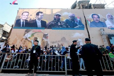 Security forces stand guard during a military parade at the Yarmuk refugee camp in southern Damascus on April 14, 2023, held to mark Al Quds Day. AFP