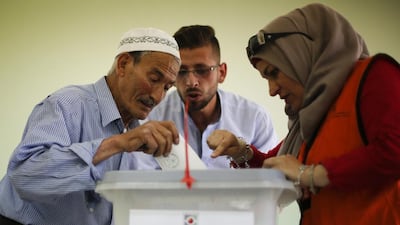 A Palestinian man casts his vote at a polling station in the West Bank city of Nablus during municipal elections on May 13, 2017. Majdi Mohammed / AP Photo