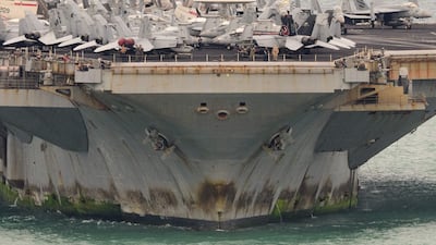 Warplanes sit on the flight deck of American aircraft carrier USS Abraham Lincoln as it heads towards the port of Laem Chabang in Thailand. AFP