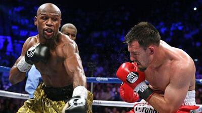 Floyd Mayweather Jr, left, landed an astonishing 60 per cent of his power punches en route to a unanimous 12-round decision. John Gurzinski / AFP