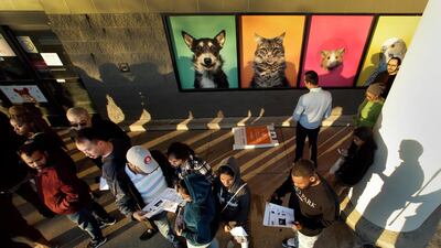 People wait in line in front of an adjacent pet store for a Best Buy store to open for an early Black Friday sale, in Overland Park, Kan. AP Photo