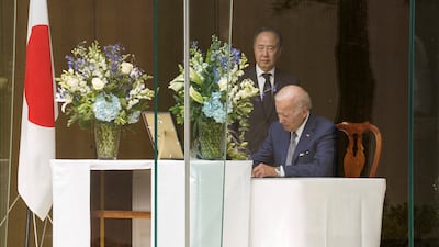 Mr Biden signs a book of condolence. Reuters