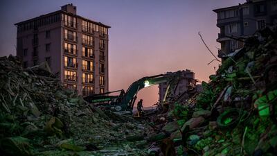 A worker stands at the site where a building once stood in Hatay. More than 41,000 people have died after an earthquake struck southern Turkey last week. EPA