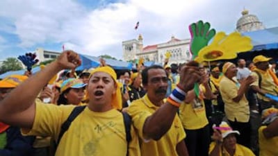 Thai anti-government protesters shout slogans as they hold the Government House in Bangkok under siege on Aug 30.