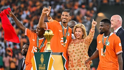 Ivory Coast forward Sebastien Haller poses with First Lady of Ivory Coast Dominique Ouattara. AFP