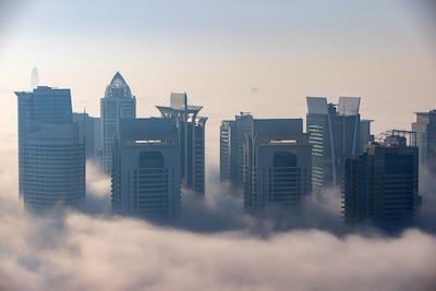 Morning fog shrouds skyscrapers in the Jumeirah Lakes Towers district of Dubai. Credit: Bloomberg