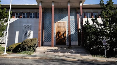 An empty flagpole stands at the entrance to the former Iranian Embassy