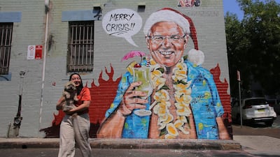 A person stands in front of a satirical mural by artist Scott Marsh depicting Australian Prime Minister Scott Morrison, on a wall in Sydney, Australia. EPA