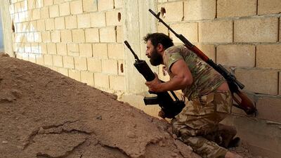 A member of forces loyal to Libya's eastern government carries his weapon during clashes with the Shura Council of Libyan Revolutionaries in Benghazi. Reuters