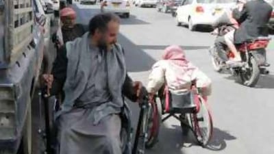 Disabled men beg for money on a street in Sana'a, Yemen.