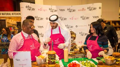 Sheikh Mohammed bin Abdullah Al Thani’s team prepares the world’s most expensive burger which sold for Dh36,700 during the Pink Caravan’s Pink Bite breast cancer charity event. Courtesy: NNC