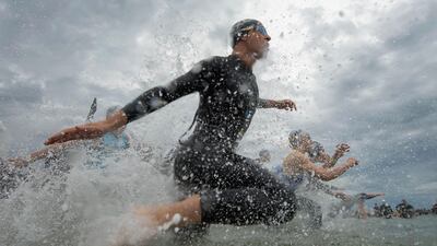 Competitors run into the water during the Elwood Triathlon in Melbourne, Australia. Quinn Rooney / Getty Images