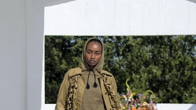 Military camouflage is remade into this loose coat and skirt for spring / summer 2022. Courtesy Qasimi