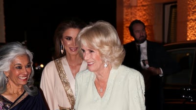 The queen consort, in a white Anna Valentine gown, attends a private dinner at the Al Husseiniya Palace in Amman on November 16, 2021. Reuters
