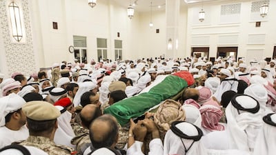The body of the deceased Emirati non-commissioned officer is carried out of the service in Alia Sultan Lootah Mosque in Al Warqa 4 for burial. Antonie Robertson / The National