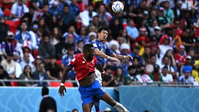 Costa Rica's Francisco Calvo and Japan's Wataru Endo jump for the ball. AFP