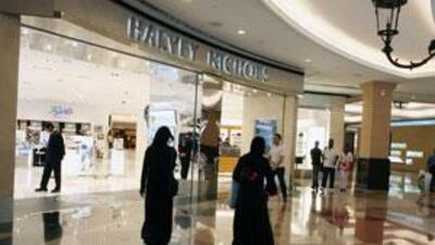Shoppers walk by the Harvey Nichols department store in the Mall of the Emirates, in Dubai.