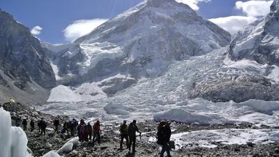 File photos of climbers walking towards their helicopter after their Mount Everest expeditions were cancelled in Solukhumbu district on April 27, 2014. On May 11, 2016, nine Nepalis arrived at the top of Mount Everest to become the first group of climbers to summit the world’s highest mountain in three years after deadly disasters forced a shutdown. Phurba Tenjing Sherpa/Reuters