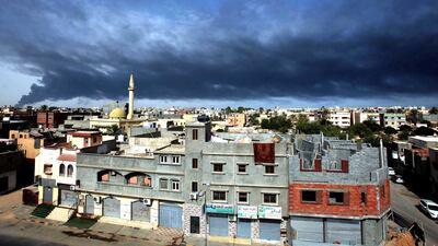 Smoke fills the sky over Tripoli after a rocket attack ignited a tank in the capital’s main fuel depot. Sabri Elmhedwi / EPA