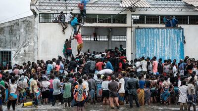 People take part in the looting sacks of rice from a warehouse which is surrounded by water after cyclone hit in Beira, Mozambique. AFP