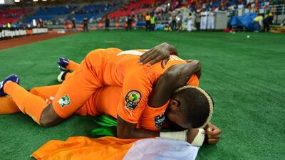 Serey Die of Ivory Coast, above, celebrates with teammate Serge Aurier, below, after they win the 2015 Africa Cup of Nations final in Bata, Equatorial Guinea on Sunday. Gavin Barker / EPA