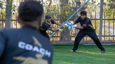 Young prospects get close catching practice at the academy in Dubai's Academic City.