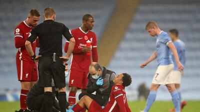 Liverpool's English defender Trent Alexander-Arnold sits on the ground after picking up an injury during the Premier League match against Liverpool at the Etihad Stadium. AFP