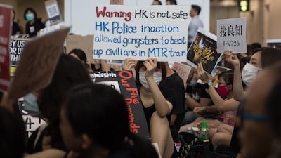 Anti-extradition bill protesters hold signs. EPA