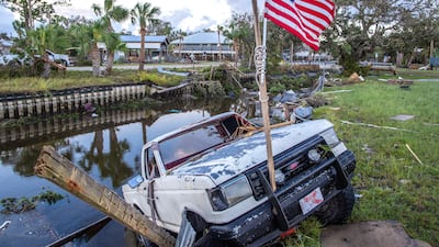 A car hangs on the ledge of a channel full of debris after Hurricane Idalia made landfall in Florida. EPA