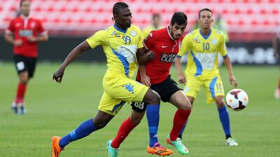 Makhete Diop, left, and his Al Dhafra teammates have gotten the better of Majed Hassan, centre, and Al Ahli of late. Sammy Dallal / The National