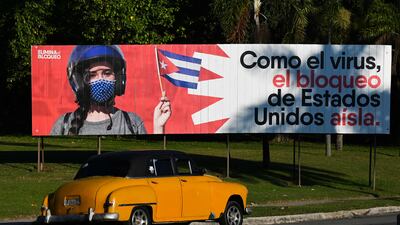 'Like the virus, the United States blockade isolates,' a banner in Havana reads. AFP