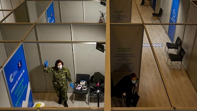 A Greek army medical staff member shows the sign of victory after she gave doses of Moderna Covid-19 vaccine at the vaccination mega center in Athens, Greece. Getty Images