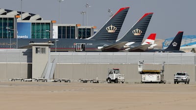 Royal Jordanian Airlines planes and those of other carriers are parked at the Queen Alia International Airport in Amman, Jordan, in February 2020. Reuters