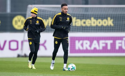Borussia Dortmund's Gabonese forward Pierre-Emerick Aubameyang, right, runs with the ball during a training session. Guido Kirchner / AFP