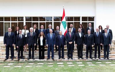 Lebanon's Parliament Speaker Nabih Berri, President Michel Aoun and prime minister Hassan Diab pose for a group photo with the now Caretaker Cabinet. AFP