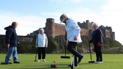 Members of the Bamburgh Croquet club play a game in Northumberland. Reuters